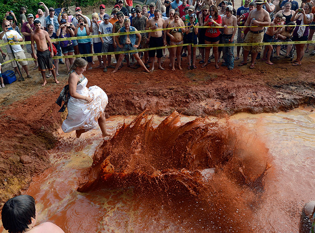 Redneck games: Ginger Buchanan, left, wears her wedding dress in the Mudpit Bellyflop