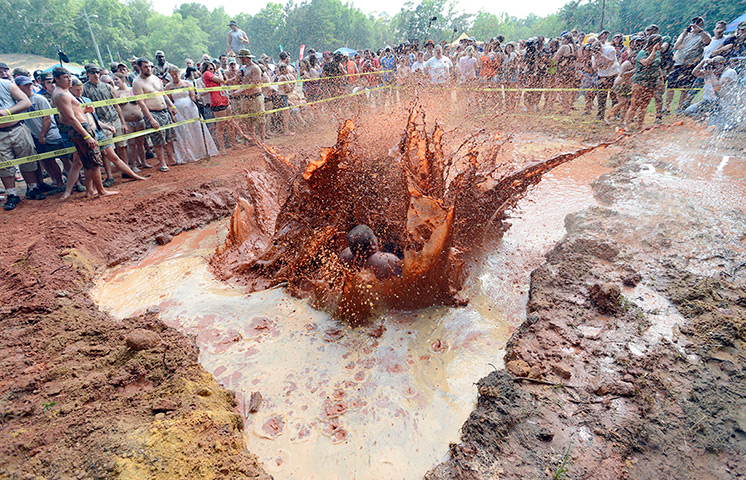 Redneck games: Men participate in the mud pit belly flop