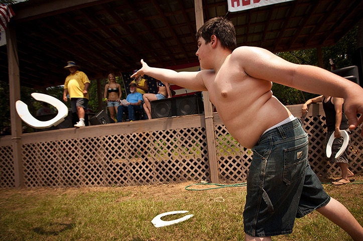 Redneck games: A competitor throws a toilet seat 