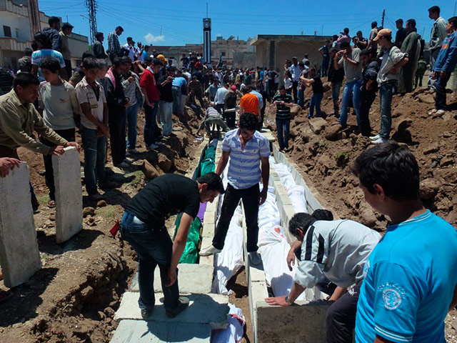 Picture Desk Live: People gather at a mass burial for the victims in Syria