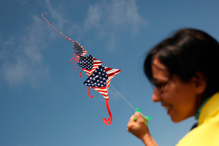 24 hours: San Francisco, California, US: A woman flies kites depicting the US flag
