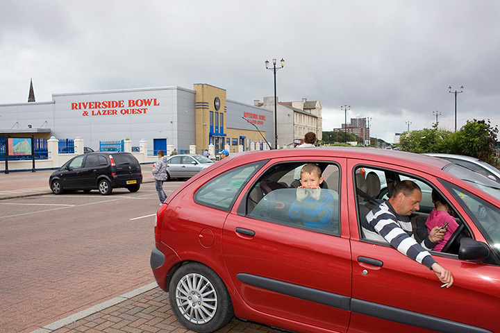 Great British Public: A young boy in the back seat of a car in New Brighton