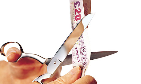Cutting a twenty pound note with scissors