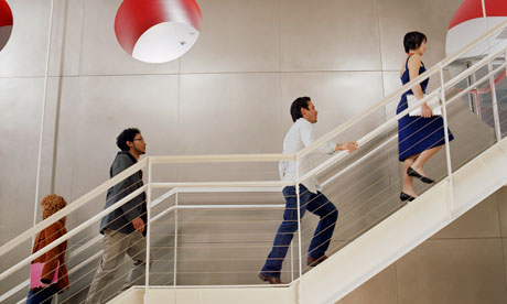 Business people walking up and down stairs