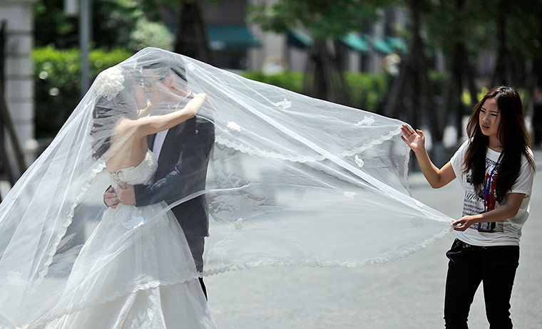 Picture Desk Live: A newly wed couple poses for a wedding photo in China