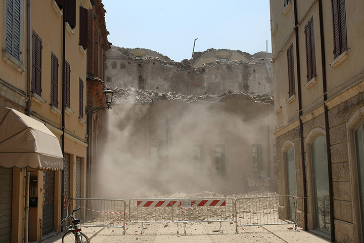 Italy earthquake: Smoke rises from a building which collapsed after a earthquake in Mirandola