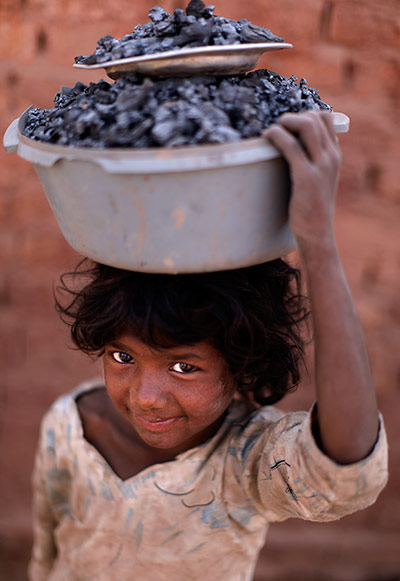 24 hours: Islamabad, Pakistan: Saima Khadim, 5, carries remains of coal