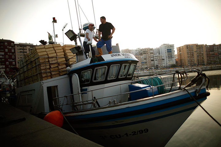 24 hours: Algeciras, Spain: Fishermen wait on a fishing boat before leaving