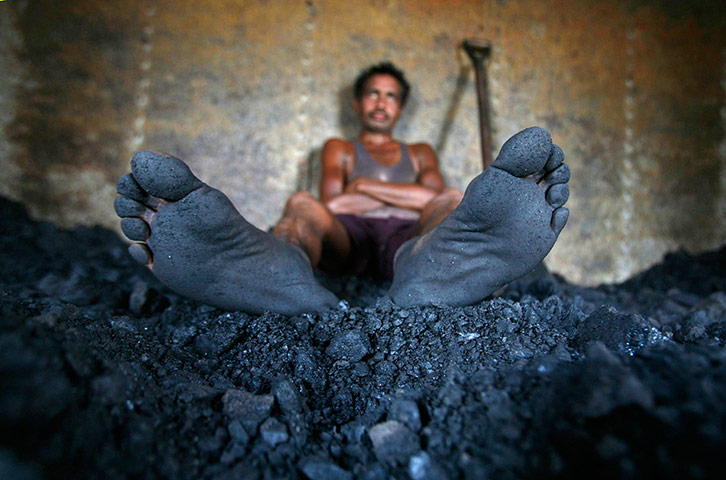 24 hours: Jammu, India: A labourer rests inside the wagon of a coal train