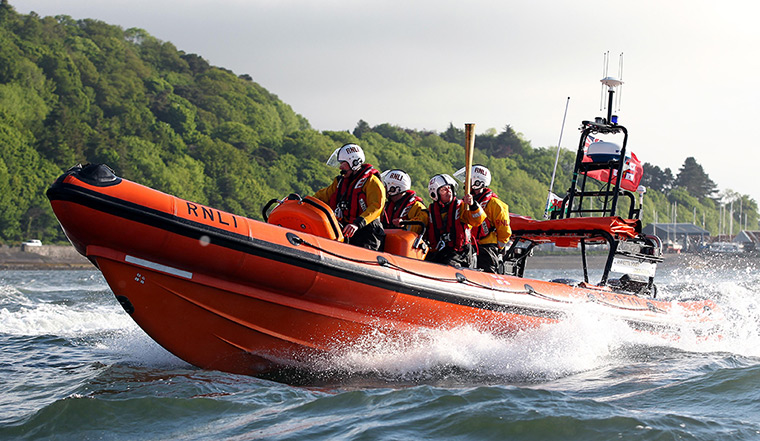 olympic torch relay: The Beaumaris RNLI lifeboat crew assist Torchbearer 002 Elen Evans 