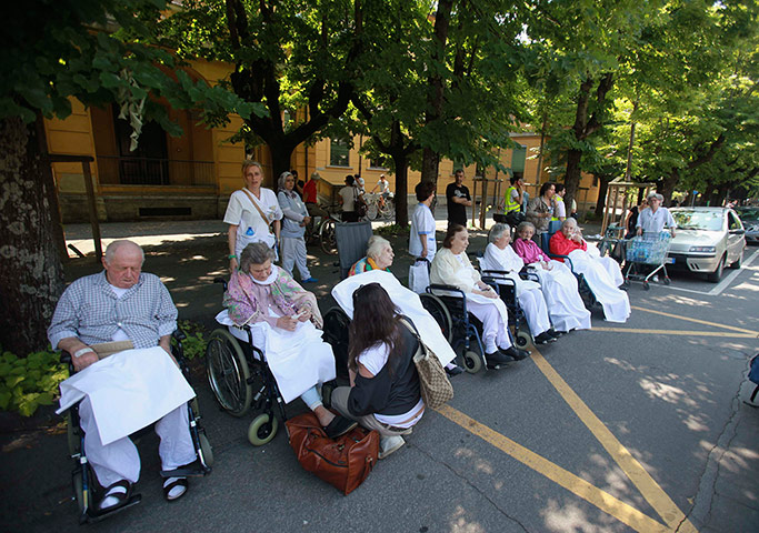 Picture Desk Live: People wait outside a hospital after an earthquake in Italy
