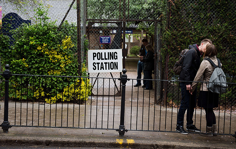 Local election: A young couple kiss before entering a polling station north London