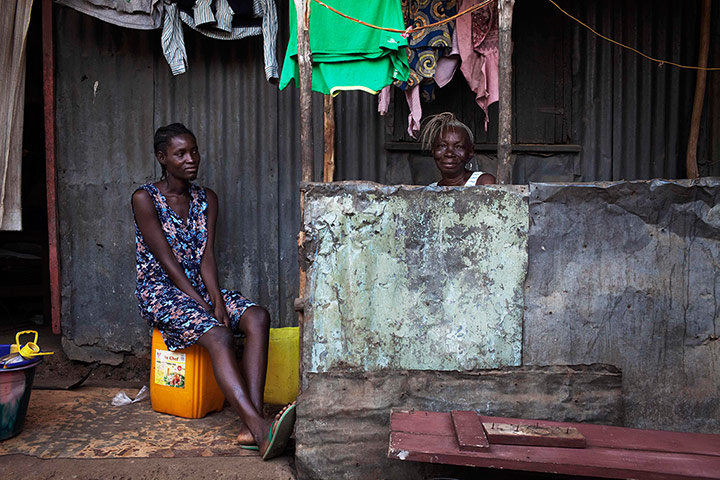 Picture Desk Live: Women sit on the porch in Sierra Leone's capital Freetown