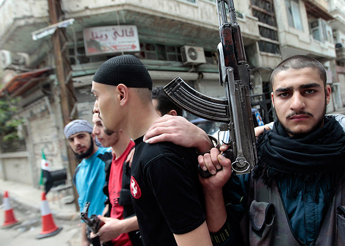 Picture Desk Live: Syrian rebels take position in the Khalidiya district of the  city of Homs