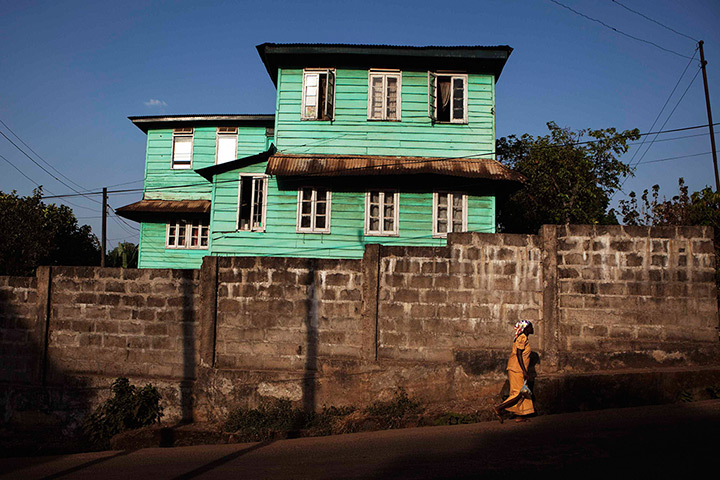 Sierra Leone Architecture: Painted wooden planks cover the facade of a Board House on King Street