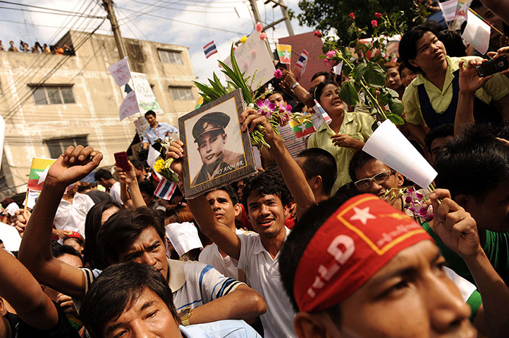 Suu Kyi visits Thailand: A supporter holds a portrait of Suu Kyi's father