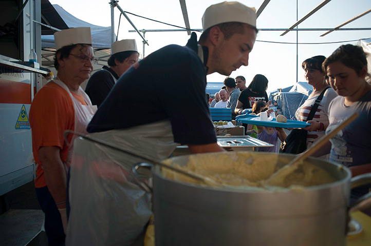 Italy earthquake: People queue for food at a displaced camp run by Protezione Civile