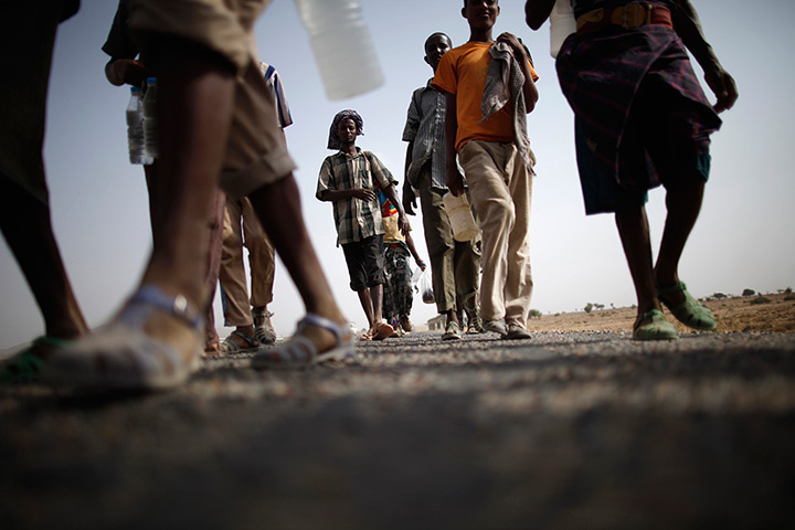 24 hours in pictures: Ethiopian migrants walk on the side of a highway 