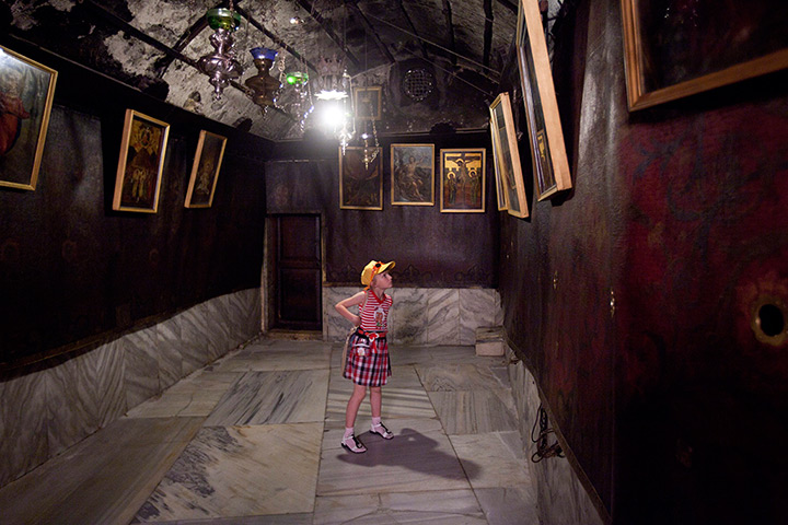 24 hours in pictures: A girl stops to look at old iconic paintings in the Church of the Nativity
