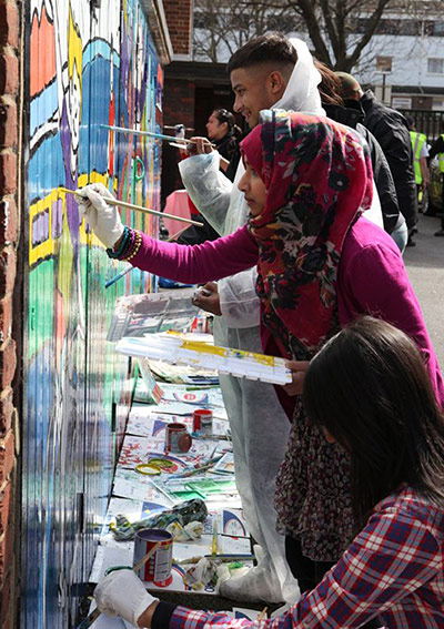 tower hamlets gallery: Young people paint a mural