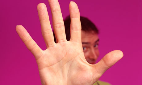 Man holding palm of hand out saying stop. Image shot 2005. Exact date unknown.