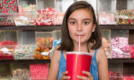 A girl drinking a soft drink or soda