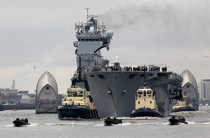 picture desk live: HMS Ocean sails through the Thames Barrier 