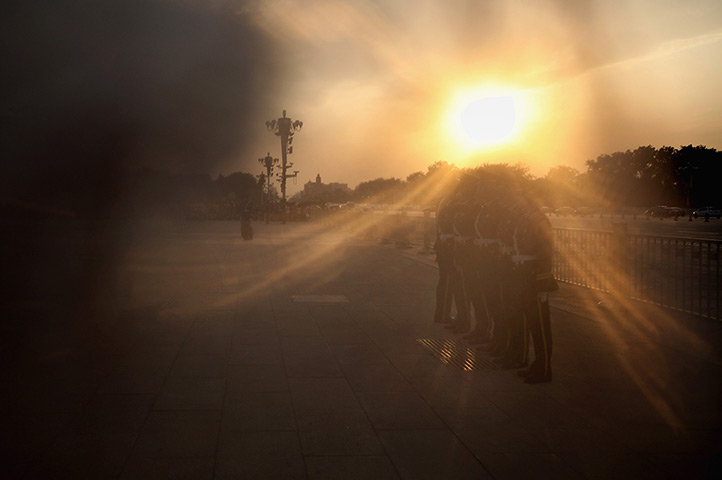 24 hours in pictures: flag lowering ceremony on Tiananmen Square 
