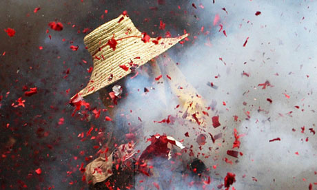 A Chinese man burns fireworks during the Dragon Boat Festival