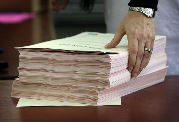 Local elections: An official prepares ballots for counting