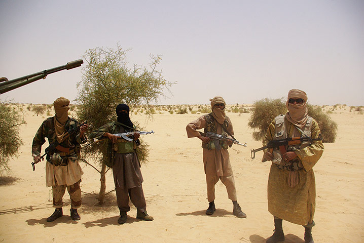 Longer View: Fighters from Islamist group Ansar Dine stand guard 
