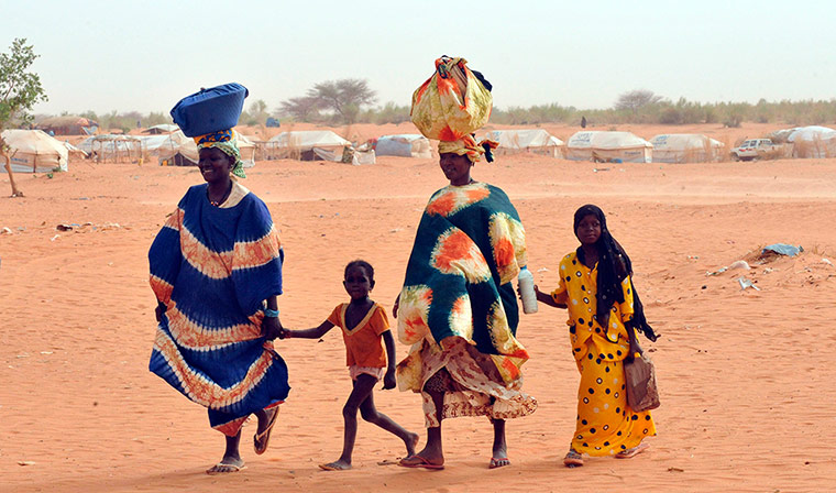 Longer View: Malian refugees walk at Mbere refugee camp