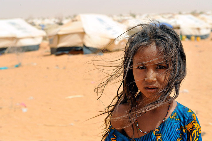 Longer View: A youmg girl poses in the M'bere refugee camp near Bassiknou