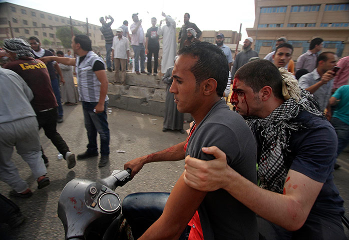 Picture Desk Live: An injured protester is evacuated by motorbike in Cairo