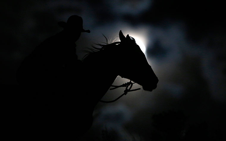 24 hours in pictures: Wrangler Nate Cummins rides by moonlight