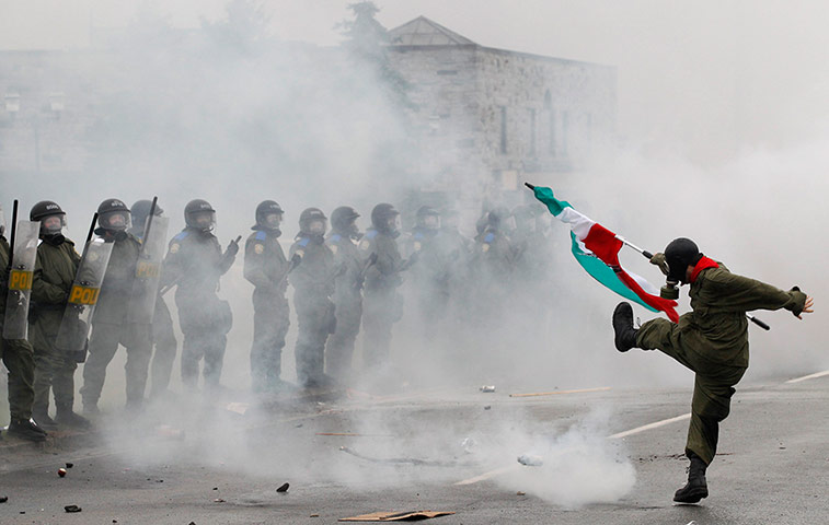 24 hours in pictures: A protester kicks a tear gas canister back towards police in Quebec