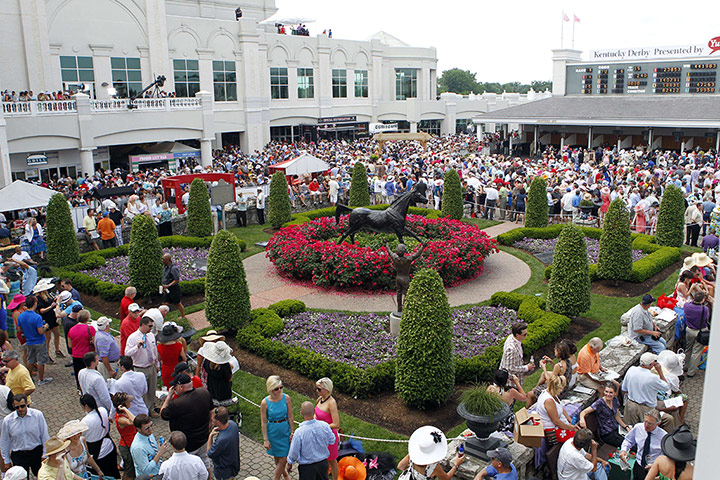 Kentucky Derby: The racing fans gather in the paddock area next to a statue of Aristide