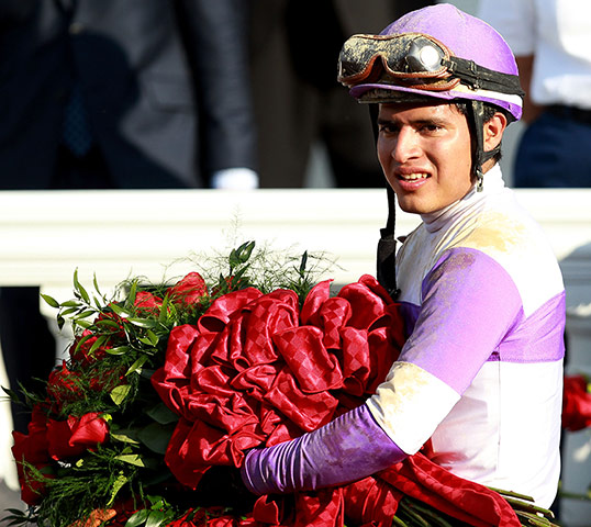Kentucky Derby: Mario Gutierrez celebrates with the roses atop I'll Have Another 