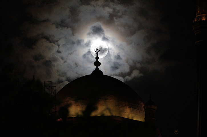 Supermoon: A full moon is seen behind the minaret of Mohamed Ali mosque, Cairo