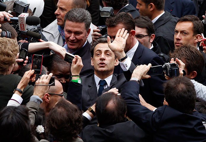 Elections: Nicolas Sarkozy waves to supporters at a voting station in Paris