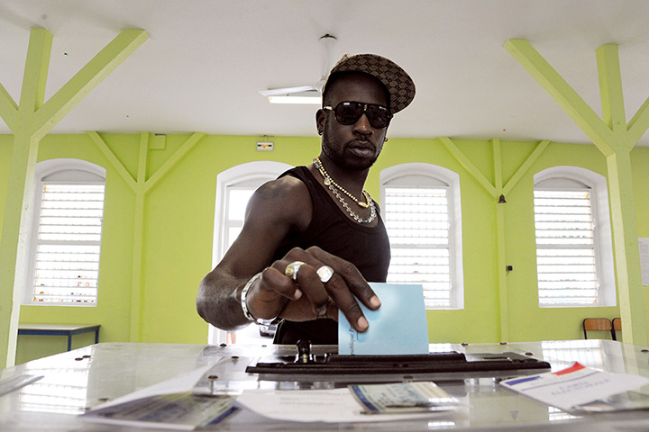 Supermoon: A man casts his ballot for the second round of the 2012 French election