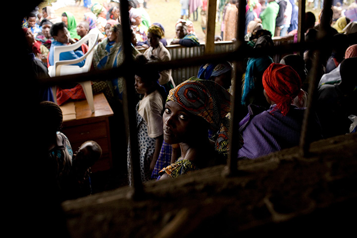 Supermoon: A Congolese woman refugee sits with others at the Nkamira transit centre