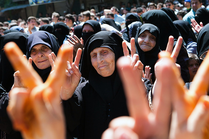 24 hours in pictures: Syrian women flash the sign for victory during a protest in Kfar Nabul