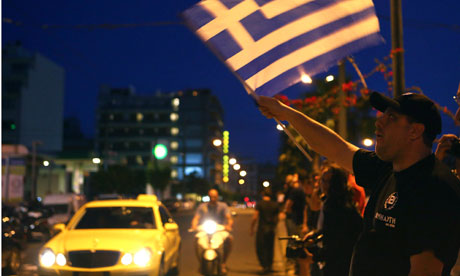 Golden Dawn supporters celebrate after early election results in Athens