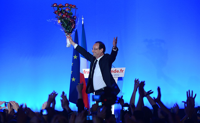 Francois Hollande wins: rancois Hollande holds a bunch of roses after speech after the results