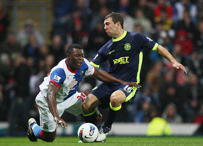wigan v blackburn: Yakubu goes down under a heavy challenge