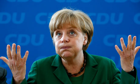 Angela Merkel reacts before a party board meeting in Berlin