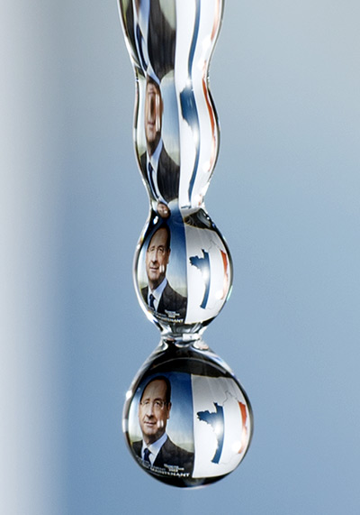 24 hours in pictures: A drop of water with reflected campaign poster of Francois Hollande
