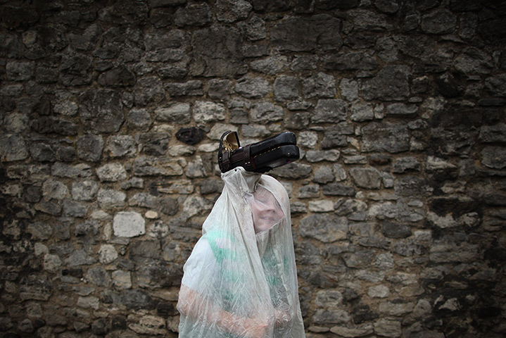 24 hours in pictures: A boy dressed as a horse runs through the parade during Sweeps Festival