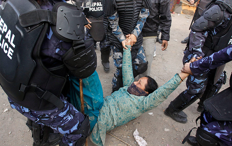 Katmandu eviction: Nepalese riot police detain a squatter
